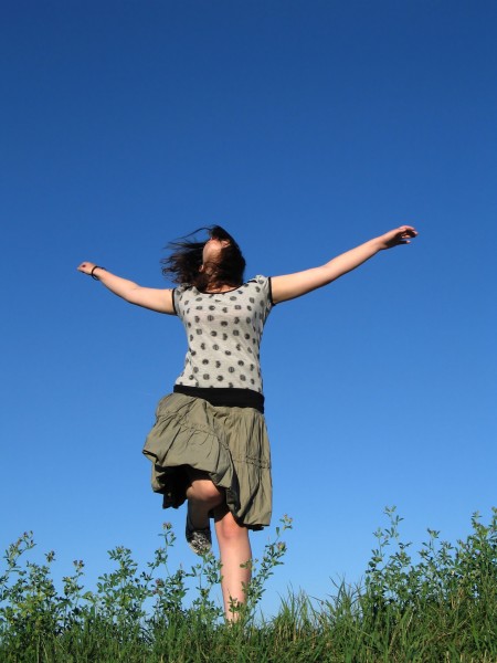 woman jumping in field