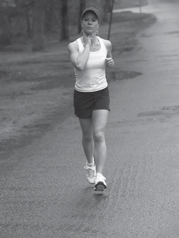 woman running and taking her pulse