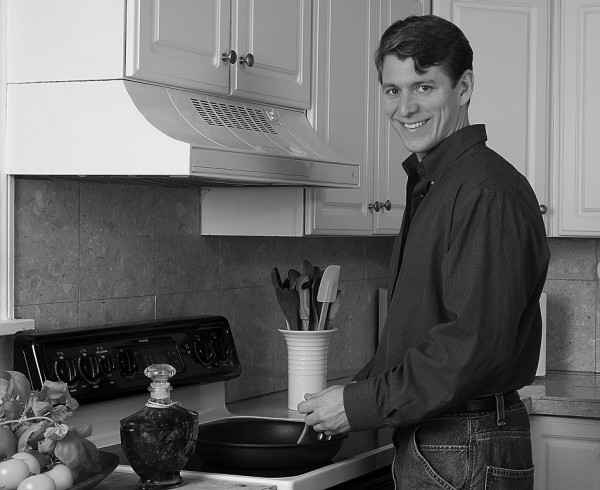 man cooking at stove