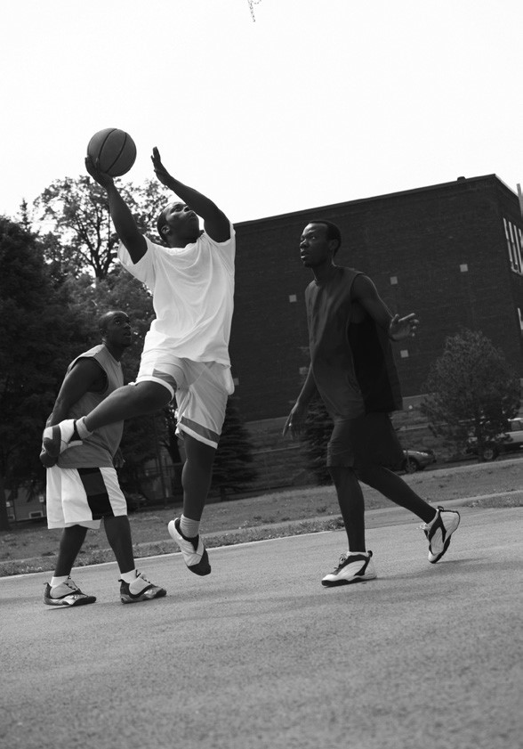 3 men playing basketball