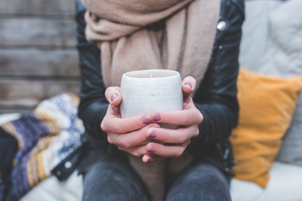 woman holding cup of coffee