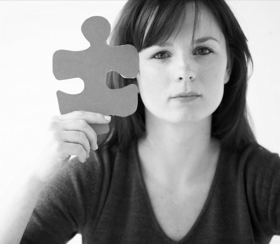 woman holding a large puzzle piece
