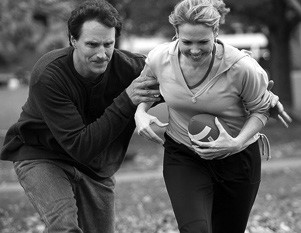 man and woman playing football