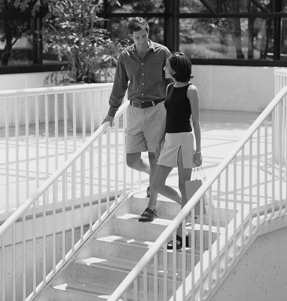 man and woman walking down steps