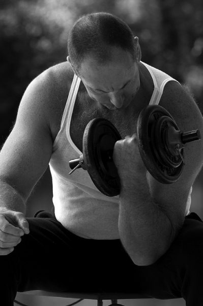 man curling weights